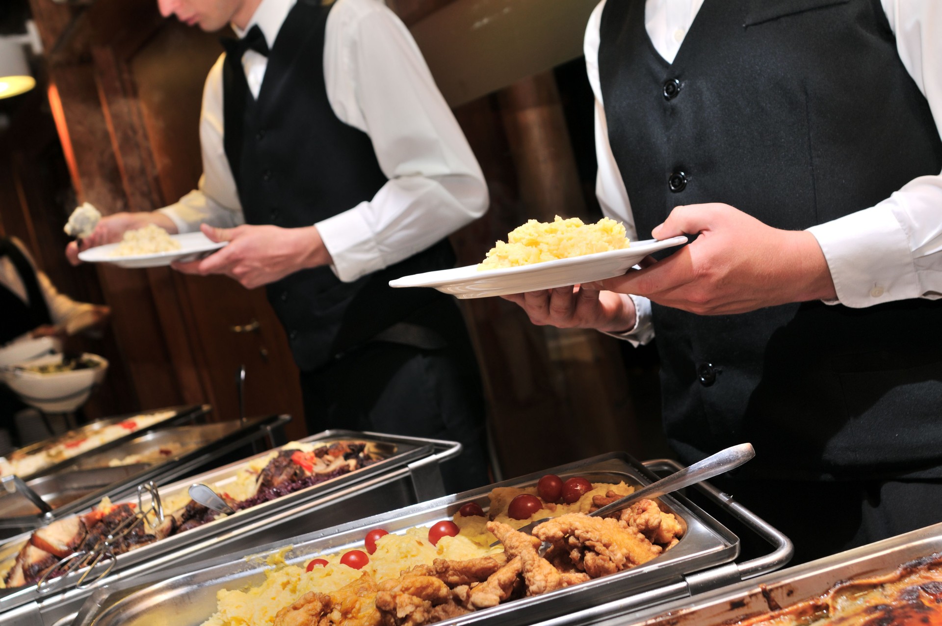 Caterers preparing food ready to be served