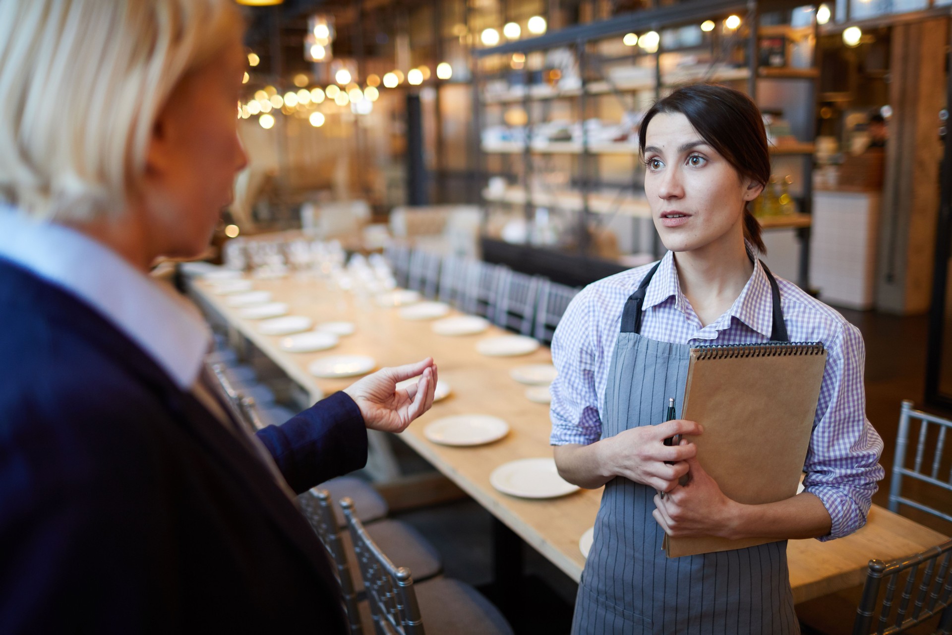 Manager Instructing Waitress in Restaurant